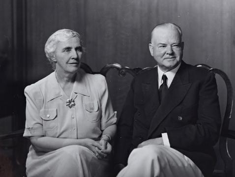 Black and white photograph of Mr. & Mrs. Herbert Hoover seated next to each other.