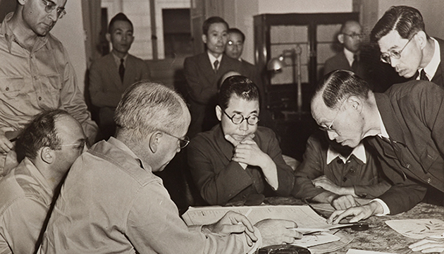 Black and white photograph of US officials inspecting records of Japanese banks, circa 1945–46