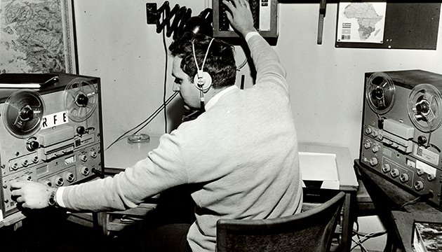 Black and white photograph of a man working in the RFE/RL Research and Analysis Department, no date