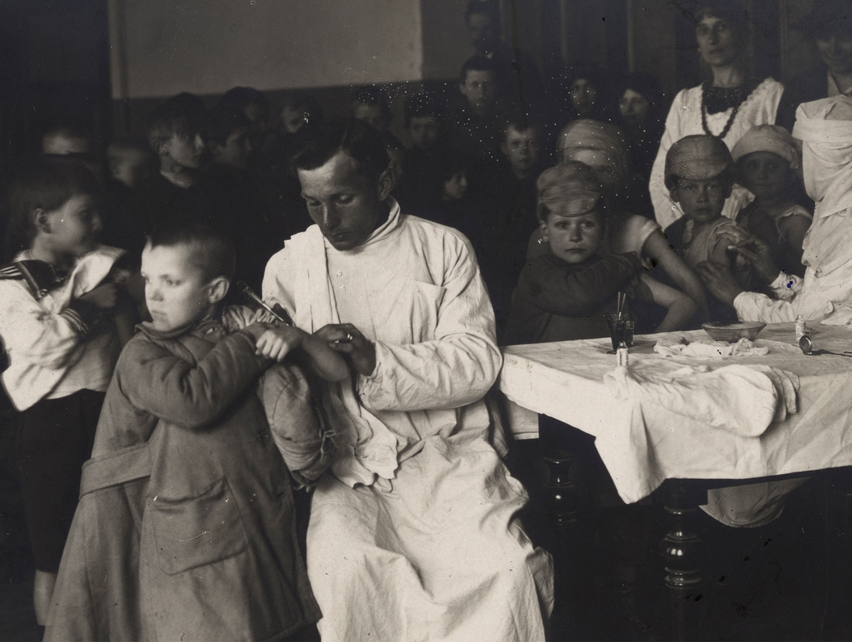 Bread and medicine image of child receiving a vaccination from doctor