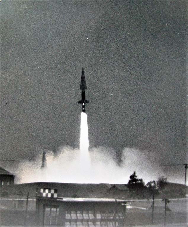 Black and white photo of Nike missile taking off from a launch pad
