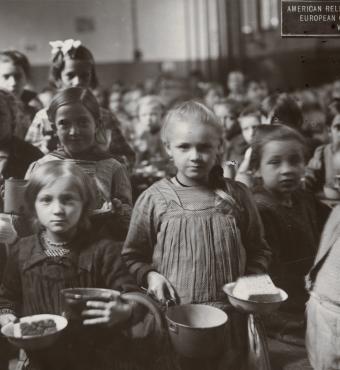 Black and white photograph of children receiving food at an American Relief Administration kitchen in Vienna