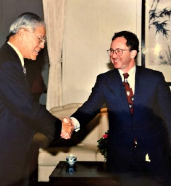 Two men wearing suits shaking hands