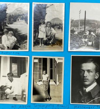 Six black and white photographs adhered to blue paper.