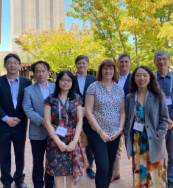 Modern China and Taiwan Workshop 2023 speakers stand in front of Hoover Tower and HHMB