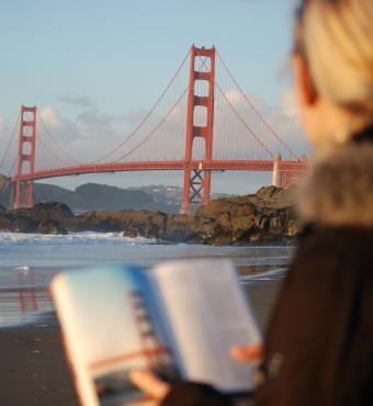Californian reading a book near the Golden Gate Bridge