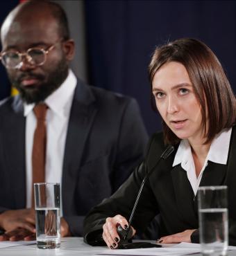 Young confident female politician in formalwear speaking in microphone stock photo (iStock)