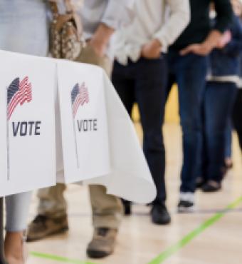 Low angle view of people lined up to vote stock photo