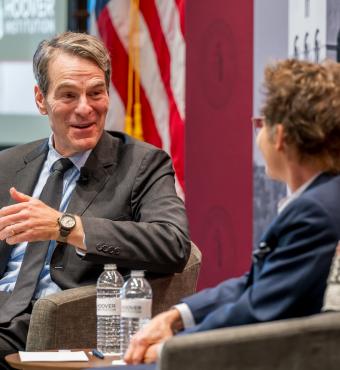 Senior Fellow John H. Cochrane speaks with SF Fed President and CEO Mary C. Daly in Shultz Auditorium on December 6, 2024. (Steve Castillo)