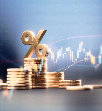 Percentage Sign On Top Of Coin Stacks Before Blue Financial Graph stock photo