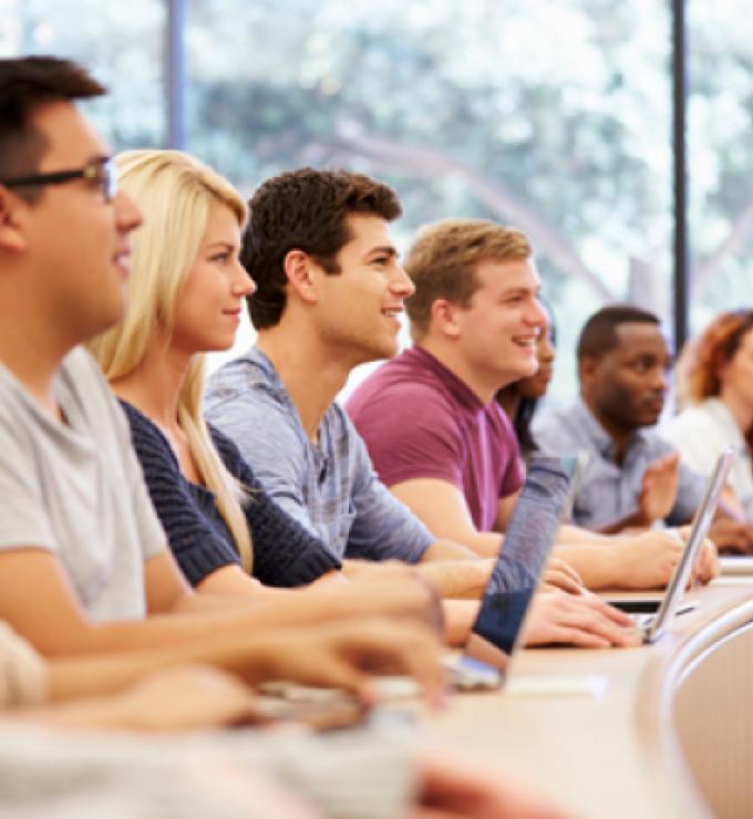 Class Of University Students Using Laptops In Lecture stock photo