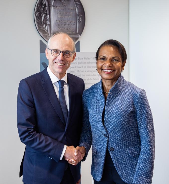 Luxembourg Prime Minister Luc Frieden and Hoover Institution Director Condoleezza Rice shake hands in Hoover’s George P. Shultz Building on November 11, 2025. (Patrick Beaudouin) 