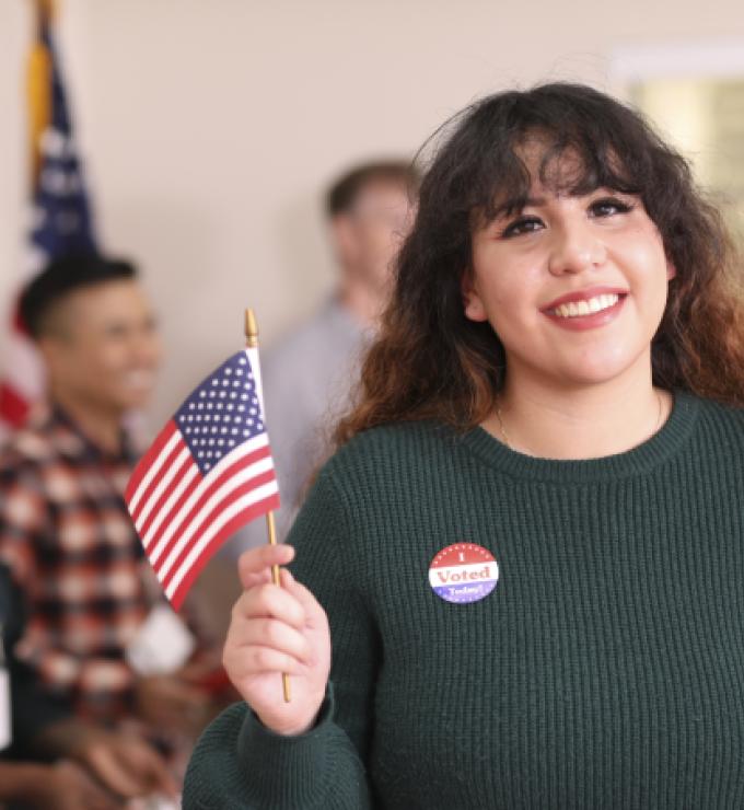 Young adult, Latin descent woman votes in USA election. - stock photo