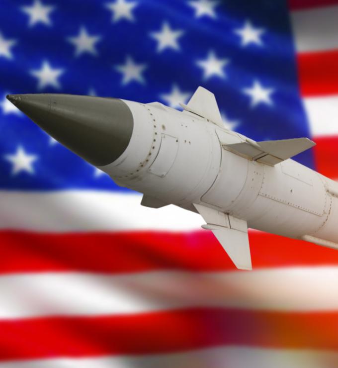 Rocket with a warhead against the background of the flag of the United States of America stock photo