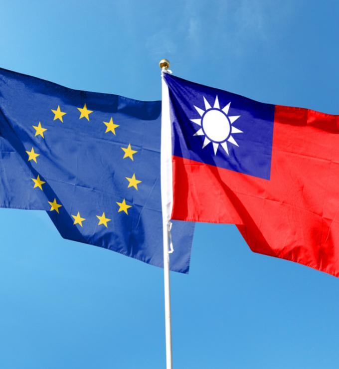 European Union flag and Taiwan flag on cloudy sky. waving in the sky stock photo