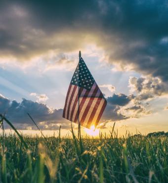 American Flag flying over a field