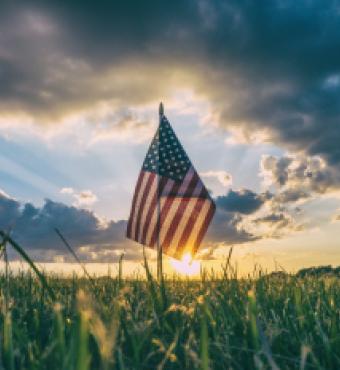 American Flag flying over a field