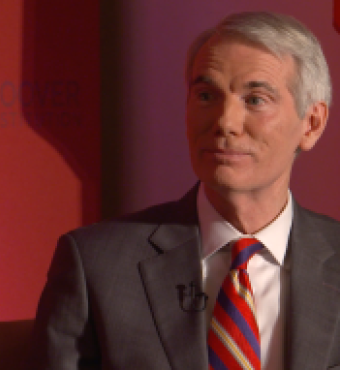 Image of Senator Rob Portman in front an orange-red background