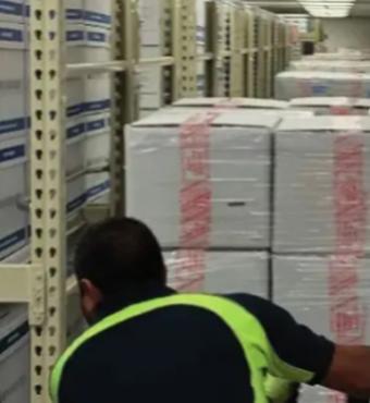 Photograph of boxed archival materials being moved