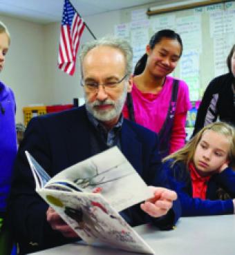 Huffman reading to schoolchildren