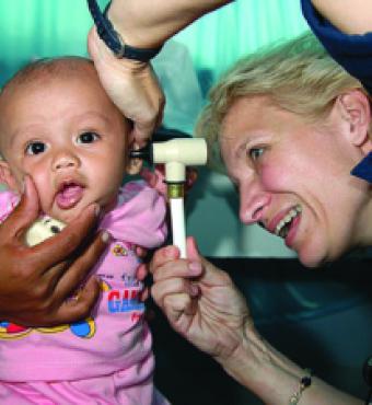 Ronda Bouwens examines a baby