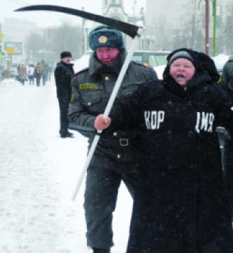 Moscow police officer detains a demonstrator