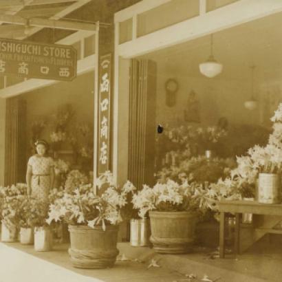 Nishiguchi Storefront woman standing amongst flowers