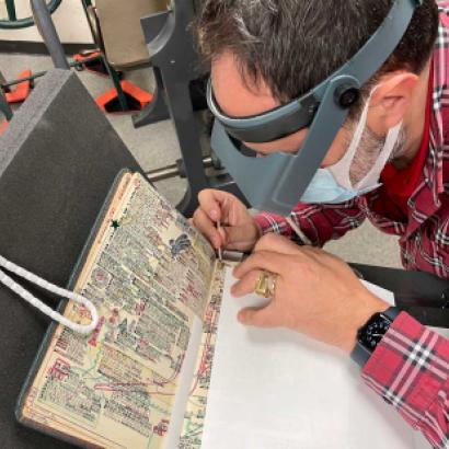 Laurent Cruveillier wearing magnifying goggle during conservation treatment of the Kitaji Bibles