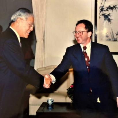 Two men wearing suits shaking hands