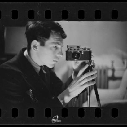 Buchman taking a self-portrait with his camera. Digitized black and white photo negative.