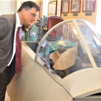 Eric Wakin looking into the cockpit of a plane on display in the American Footprint Museum