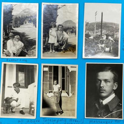 Six black and white photographs adhered to blue paper.