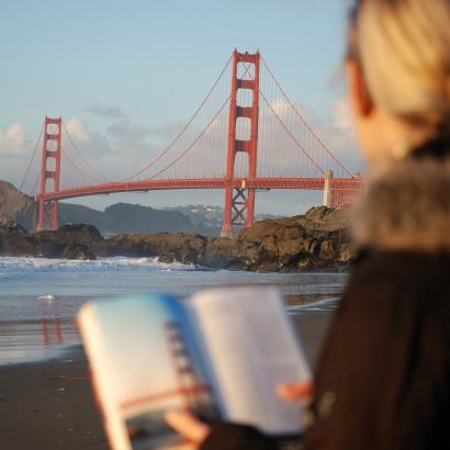 Californian reading a book near the Golden Gate Bridge