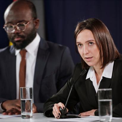 Young confident female politician in formalwear speaking in microphone stock photo (iStock)