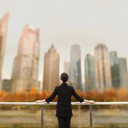 Young woman standing with view of buildings in city downtown