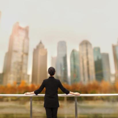 Young woman standing with view of buildings in city downtown