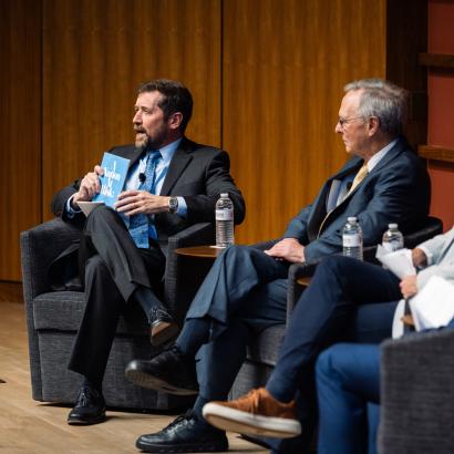 Hoover Education Success Initiative Director Stephen Bowen (left) holds a copy of the original 1983 A Nation at Risk report on US public education during a panel discussing the history of public education reform on January 10, 2025. (Patrick Beaudouin)
