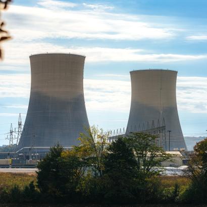 Green Trees surrounding the tall Cooling Towers of a Nuclear Power Plant in Tennessee on a Sunny Autumn Day stock photo