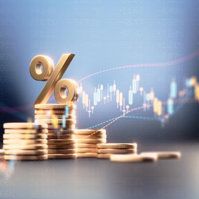 Percentage Sign On Top Of Coin Stacks Before Blue Financial Graph stock photo