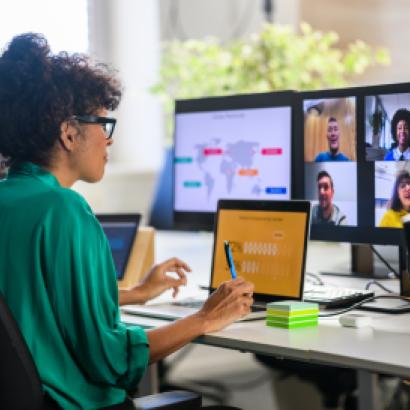 Woman discussing report with remote workers stock photo
