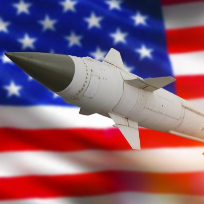 Rocket with a warhead against the background of the flag of the United States of America stock photo