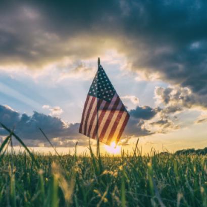 American Flag flying over a field