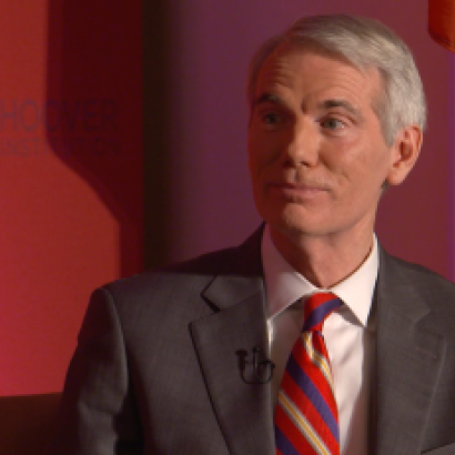 Image of Senator Rob Portman in front an orange-red background