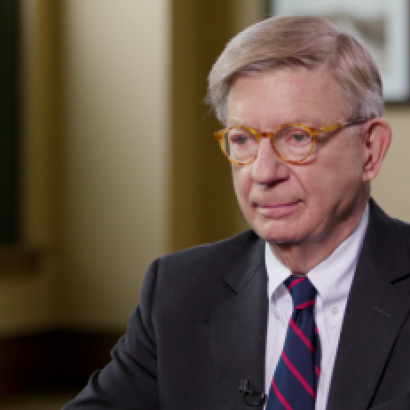 Image of George F. Will sitting at a table.