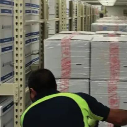 Photograph of boxed archival materials being moved