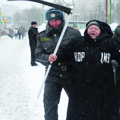 Moscow police officer detains a demonstrator