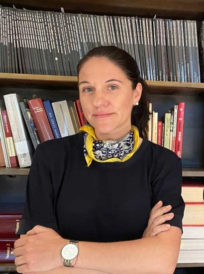 Katharina Friedla standing in front of book case