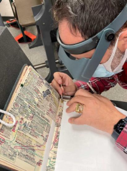 Laurent Cruveillier wearing magnifying goggle during conservation treatment of the Kitaji Bibles