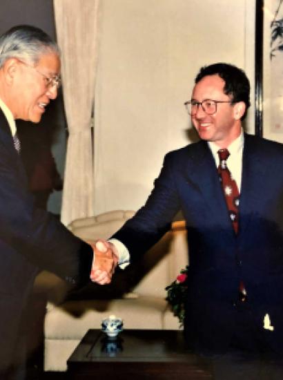 Two men wearing suits shaking hands