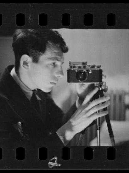 Buchman taking a self-portrait with his camera. Digitized black and white photo negative.